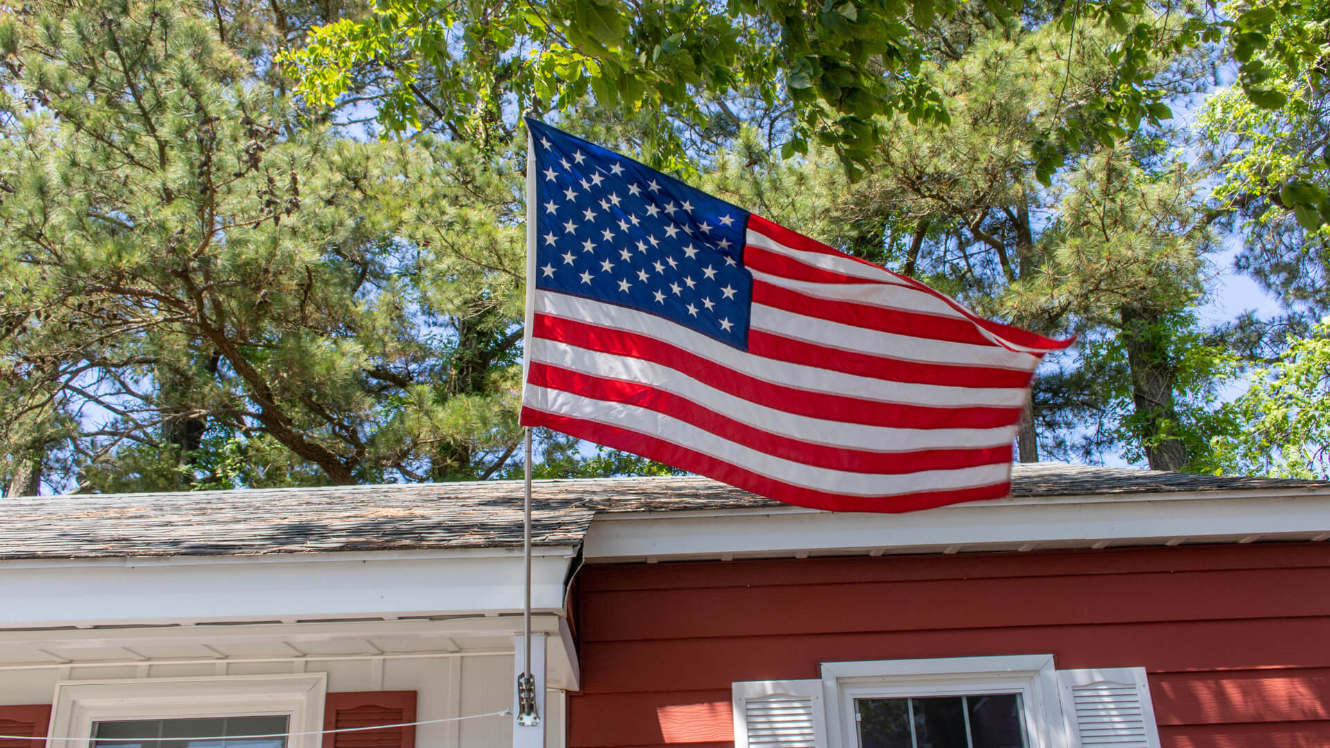 Vacation Homes 600-613 building exterior with American flag